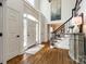 Grand foyer with hardwood floors, a staircase, and a high ceiling, creating a welcoming entrance at 10327 Oak Pond Cir, Charlotte, NC 28277