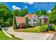 Elegant two-story home with manicured landscaping, a circular driveway, and a welcoming front entrance, set on a lush lot at 10327 Oak Pond Cir, Charlotte, NC 28277