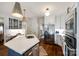 Modern kitchen featuring stainless steel appliances, custom cabinetry, and a large island with pendant lighting at 10327 Oak Pond Cir, Charlotte, NC 28277