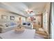 Spacious living area with sofas, coffee table, and a pool table visible in the background at 10327 Oak Pond Cir, Charlotte, NC 28277