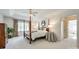 Spacious main bedroom boasts a four-poster bed, tray ceiling, and abundant natural light at 10327 Oak Pond Cir, Charlotte, NC 28277