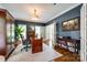 Spacious office with a large desk, hardwood floors, and French doors leading to another room at 10327 Oak Pond Cir, Charlotte, NC 28277