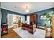 Spacious office with a large desk, hardwood floors, and French doors leading to another room at 10327 Oak Pond Cir, Charlotte, NC 28277