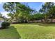 The spacious backyard features well maintained green grass, trees, and wooden fence at 104 Berry St, Fort Mill, SC 29715