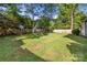 Large grassy backyard is enclosed with a wooden fence for privacy at 104 Berry St, Fort Mill, SC 29715