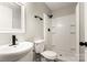 Well-lit bathroom features a white shower, toilet, sink, black hardware, and a bright mirror at 104 Berry St, Fort Mill, SC 29715