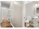 Bathroom featuring white vanity with black hardware, modern commode, and white walls with wood-look flooring at 104 Berry St, Fort Mill, SC 29715