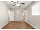 A bedroom with new laminate flooring, neutral walls, a ceiling fan, and a window at 104 Berry St, Fort Mill, SC 29715