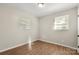 Bedroom with hardwood flooring and natural light from two bright windows at 104 Berry St, Fort Mill, SC 29715