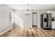 Dining area showcasing hardwood floors, chandelier lighting, and stainless steel refrigerator at 104 Berry St, Fort Mill, SC 29715