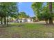Wide shot of the home, revealing the spacious yard and mature trees at 104 Berry St, Fort Mill, SC 29715