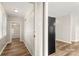 Hallway featuring painted brick wall, white trim, grey walls, with view into updated kitchen at 104 Berry St, Fort Mill, SC 29715
