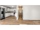 Hallway featuring new wood floors, white cabinets, and stainless steel refrigerator at 104 Berry St, Fort Mill, SC 29715
