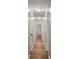 Hallway featuring wood-look floors, access to multiple rooms, and white walls at 104 Berry St, Fort Mill, SC 29715
