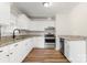 Updated kitchen featuring white cabinetry, stainless appliances, granite countertops, and hardwood style floors at 104 Berry St, Fort Mill, SC 29715