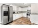 Bright kitchen featuring white cabinets, granite countertops, stainless steel appliances, and wood-look flooring at 104 Berry St, Fort Mill, SC 29715