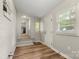 Mud room featuring painted brick, view to kitchen, exterior door, and wood-look flooring at 104 Berry St, Fort Mill, SC 29715