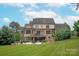 Backyard with a patio, seating and an outdoor kitchen and a large, grassy lawn at 11000 Strike The Gold Ln, Waxhaw, NC 28173