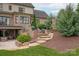 Multi-tiered backyard with stone steps and outdoor entertaining spaces at 11000 Strike The Gold Ln, Waxhaw, NC 28173