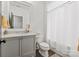 This bright bathroom features a gray vanity with a marble countertop and a shower with a curtain at 11000 Strike The Gold Ln, Waxhaw, NC 28173