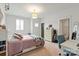 Well-lit bedroom with a bed, desk, and dresser, perfect for studying or relaxing at 11000 Strike The Gold Ln, Waxhaw, NC 28173