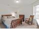 Bright bedroom with wood bed frame and rocking chair, offering a relaxing atmosphere at 11000 Strike The Gold Ln, Waxhaw, NC 28173