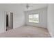 Neutral bedroom with light beige carpet, white walls and trim, and a ceiling fan at 11000 Strike The Gold Ln, Waxhaw, NC 28173