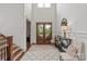 Elegant foyer with high ceilings, wood floors, and a decorative area rug at 11000 Strike The Gold Ln, Waxhaw, NC 28173