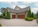 Spacious three-car garage with beautiful wood doors and well-maintained landscaping at 11000 Strike The Gold Ln, Waxhaw, NC 28173