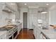 Chef's kitchen with stainless steel appliances, custom cabinetry, granite countertops, and subway tile backsplash at 11000 Strike The Gold Ln, Waxhaw, NC 28173