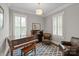 Inviting living room features classic piano, plantation shutters, and leather furnishings at 11000 Strike The Gold Ln, Waxhaw, NC 28173