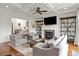 Bright living room with fireplace, built-in shelves, coffered ceiling, and lots of seating at 11000 Strike The Gold Ln, Waxhaw, NC 28173
