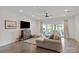 Modern living room featuring polished concrete floors, sliding glass doors to patio, and comfortable seating at 11000 Strike The Gold Ln, Waxhaw, NC 28173