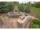 Outdoor lounge area with stone fireplace, grill, and seating at 11000 Strike The Gold Ln, Waxhaw, NC 28173