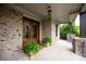 Welcoming covered porch with brick accents and decorative plants, perfect for relaxing at 11000 Strike The Gold Ln, Waxhaw, NC 28173