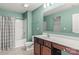 A well-lit bathroom features a spacious vanity, a large mirror, and a shower-tub combination with green walls at 111 Tilton Dr, Mooresville, NC 28115