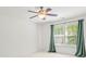 A bright bedroom with a ceiling fan and natural light creating a calming atmosphere to relax in at 111 Tilton Dr, Mooresville, NC 28115