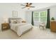 Inviting bedroom features soft bedding, natural light, and minimalist decor to create a peaceful retreat at 111 Tilton Dr, Mooresville, NC 28115