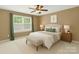 Charming bedroom features neutral tones, inviting furnishings, soft lighting, and a ceiling fan at 111 Tilton Dr, Mooresville, NC 28115