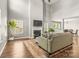 Bright living room with fireplace, hardwood floors, and views to the dining area at 111 Tilton Dr, Mooresville, NC 28115