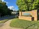 Stone sign for 'Bennington' neighborhood with manicured landscaping and a glimpse of homes in the background at 111 Tilton Dr, Mooresville, NC 28115