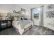 Bright bedroom features modern decor, large windows, comfortable bed, and accent wall at 1113 Hallman Branch Ln, Lincolnton, NC 28092