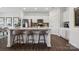 Modern white kitchen with a center island, stainless steel appliances, and stylish bar stool seating at 1113 Hallman Branch Ln, Lincolnton, NC 28092