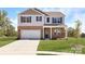 Charming two-story home featuring a brick-and-siding exterior, a well-manicured lawn, and a concrete driveway at 113 Way Cross Ln, Troutman, NC 28166