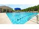 Beautiful community pool featuring clear blue water, lounge chairs, umbrellas, and a serene environment for enjoyable leisure at 113 Way Cross Ln, Troutman, NC 28166