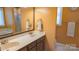 Bathroom featuring double vanity, large mirror, and tiled floors for a clean, modern look at 12601 Guardhouse Ct, Charlotte, NC 28262