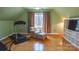 Cozy bedroom features a chair, treadmill, and built-in shelving, ideal for relaxation and exercise at 12601 Guardhouse Ct, Charlotte, NC 28262