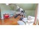 Bright bonus room with fitness equipment, hardwood floors, window and cozy chair at 12601 Guardhouse Ct, Charlotte, NC 28262