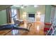Bright bonus room with fitness equipment, hardwood floors, window and cozy chair at 12601 Guardhouse Ct, Charlotte, NC 28262