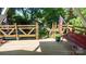 Outdoor wooden deck features sturdy railings, a cozy bench, and a view of nature at 12601 Guardhouse Ct, Charlotte, NC 28262